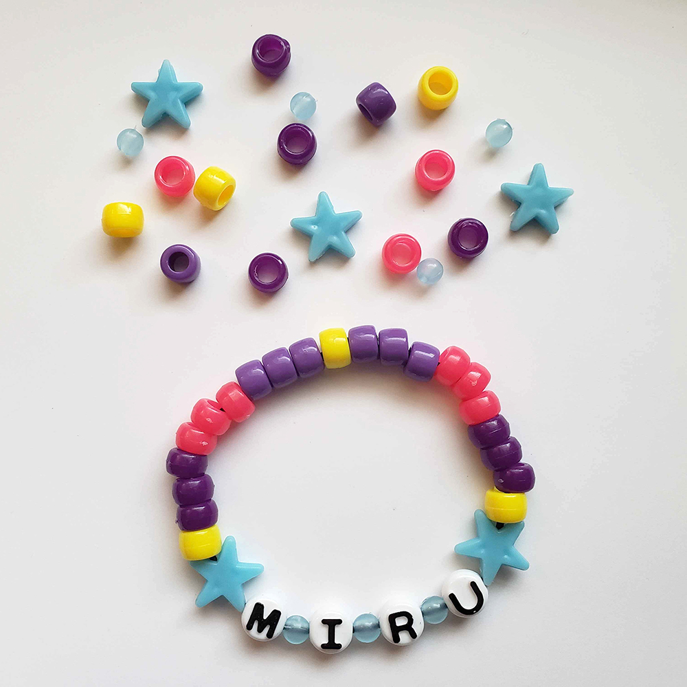 a chunky plastic-beaded bracelet themed after another player's original character