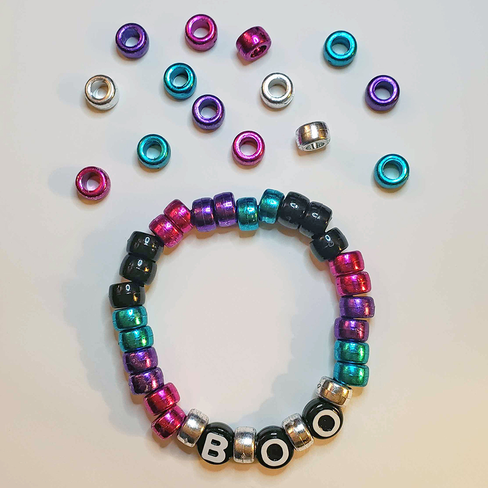 a chunky plastic-beaded bracelet themed after another player's original character