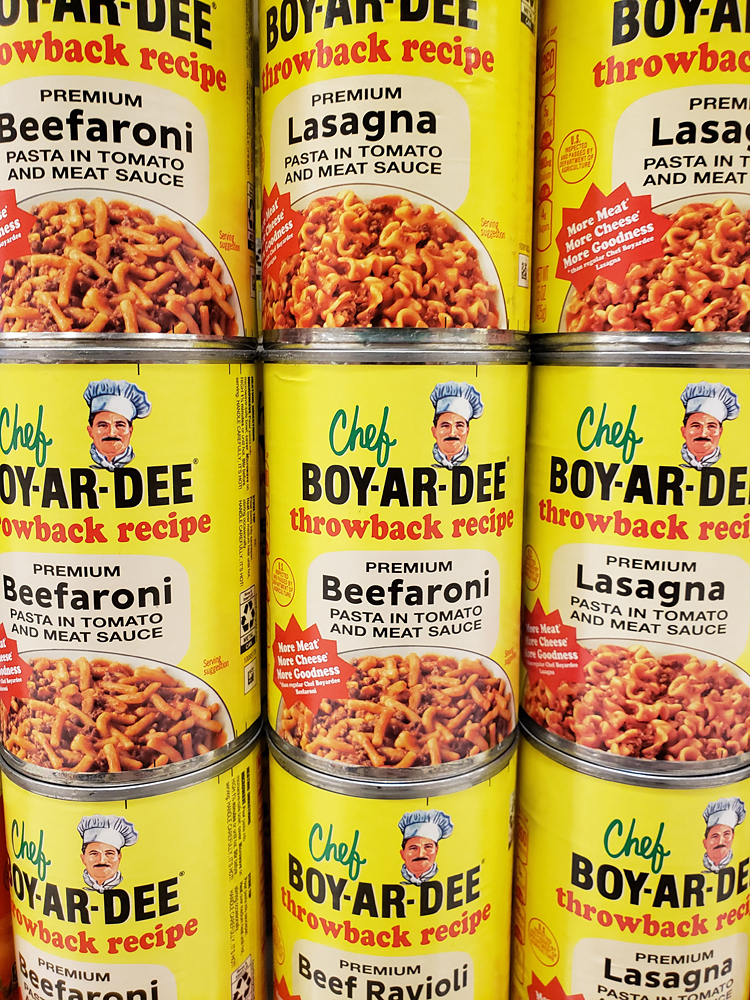 a grocery store display of pasta cans with vintage style labels