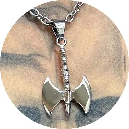 a silver chain with a silver battleaxe pendant hanging from it
