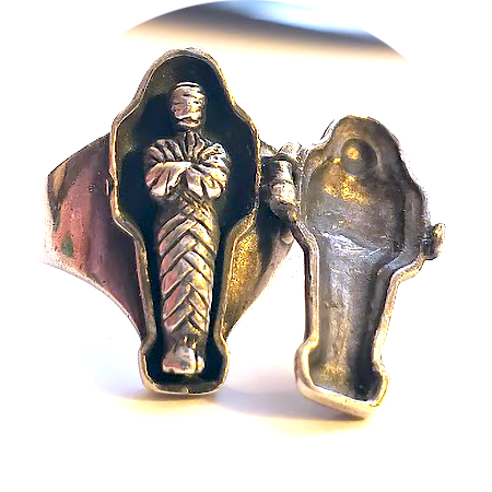 a silver ring shaped like an Egyptian sarcophagus; it opens to reveal a mummy inside