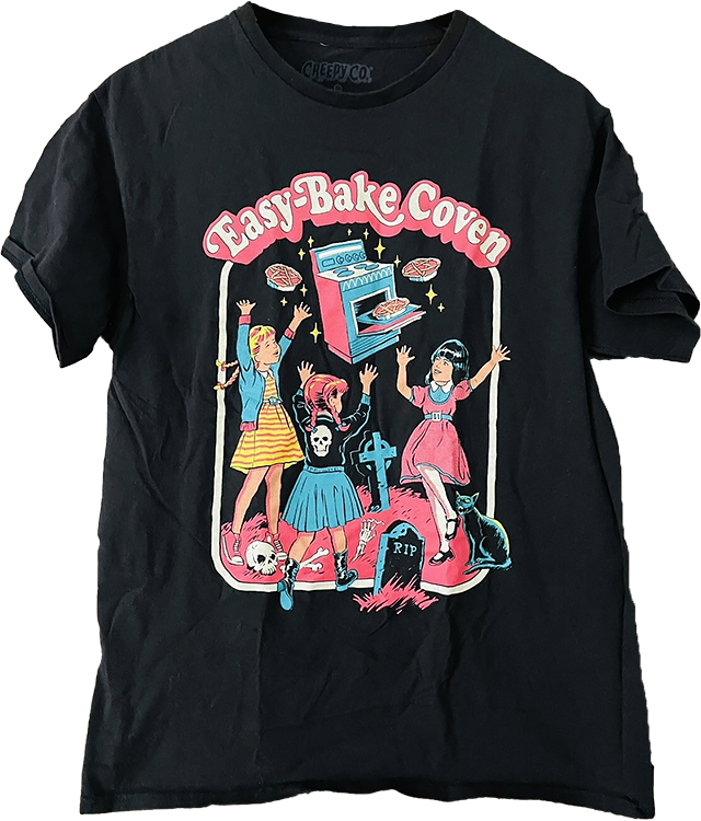 a black t-shirt featuring a 50s childrens-book style design of several little girls in a graveyard, baking pies with a floating toy oven, captioned 'Easy Bake Coven'