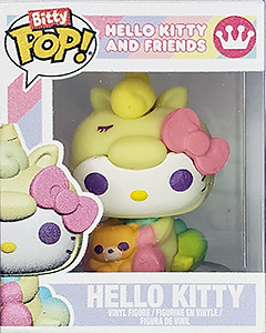 a miniature plastic 'Funko Pops' box with a tiny figure of Hello Kitty, clothed in a yellow unicorn onesie and holding a teddy bear