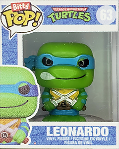 a miniature plastic 'Funko Pops' box with a tiny figure of Leonardo from Teenage Mutant Ninja Turtles (classic cartoon design)