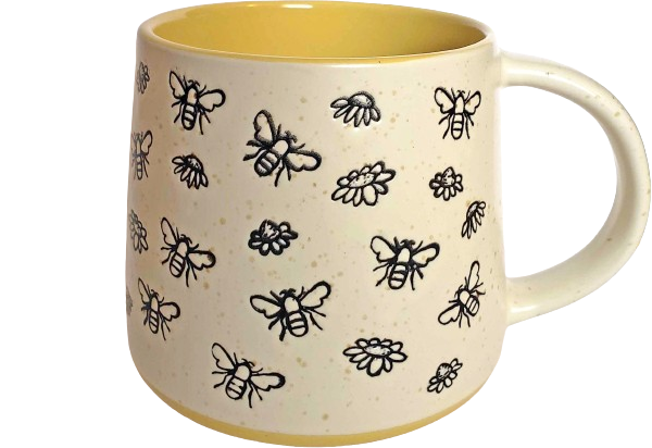 a white mug with yellow accents, featuring black-outlined bees stamped all over.