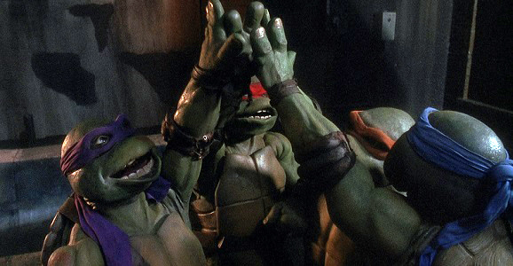 The Turtles celebrating with a 'Cowabunga!'