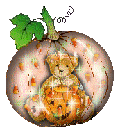 a snowglobe-type pumpkin with a teddy bear and candy corn inside